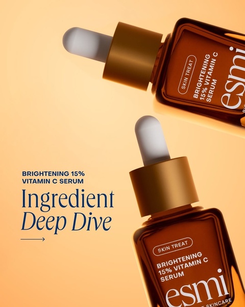 A high-end, 4:5 ratio product-focused creative featuring two bottles of Vitamin C serum against a warm, minimalist gradient background.